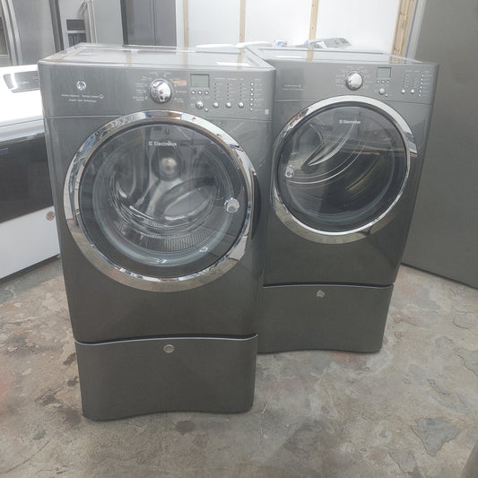 Used Electrolux 4.3 cubic ft Front Load Washer and 8 cubi ft Electric Dryer Set with Pedestals