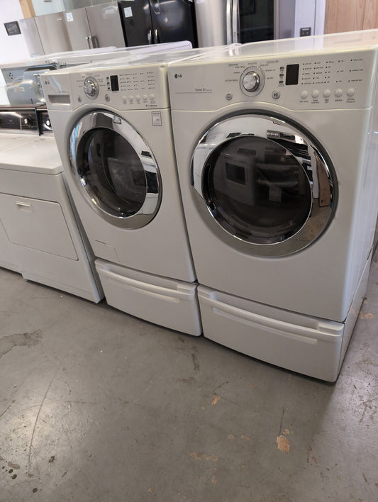 Used LG 5 cubic foot front load washer and 7.5 cubic foot electric dryer set with pedestals