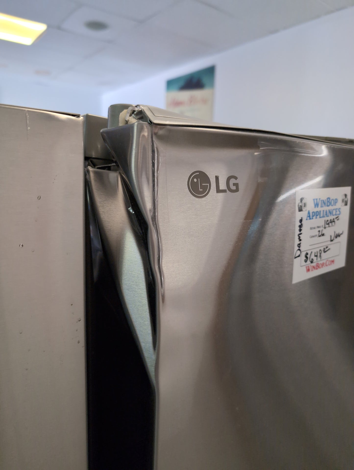 New LG counter depth 26 cubic foot stainless steel French door refrigerator with ice and water in the door. Door Damage