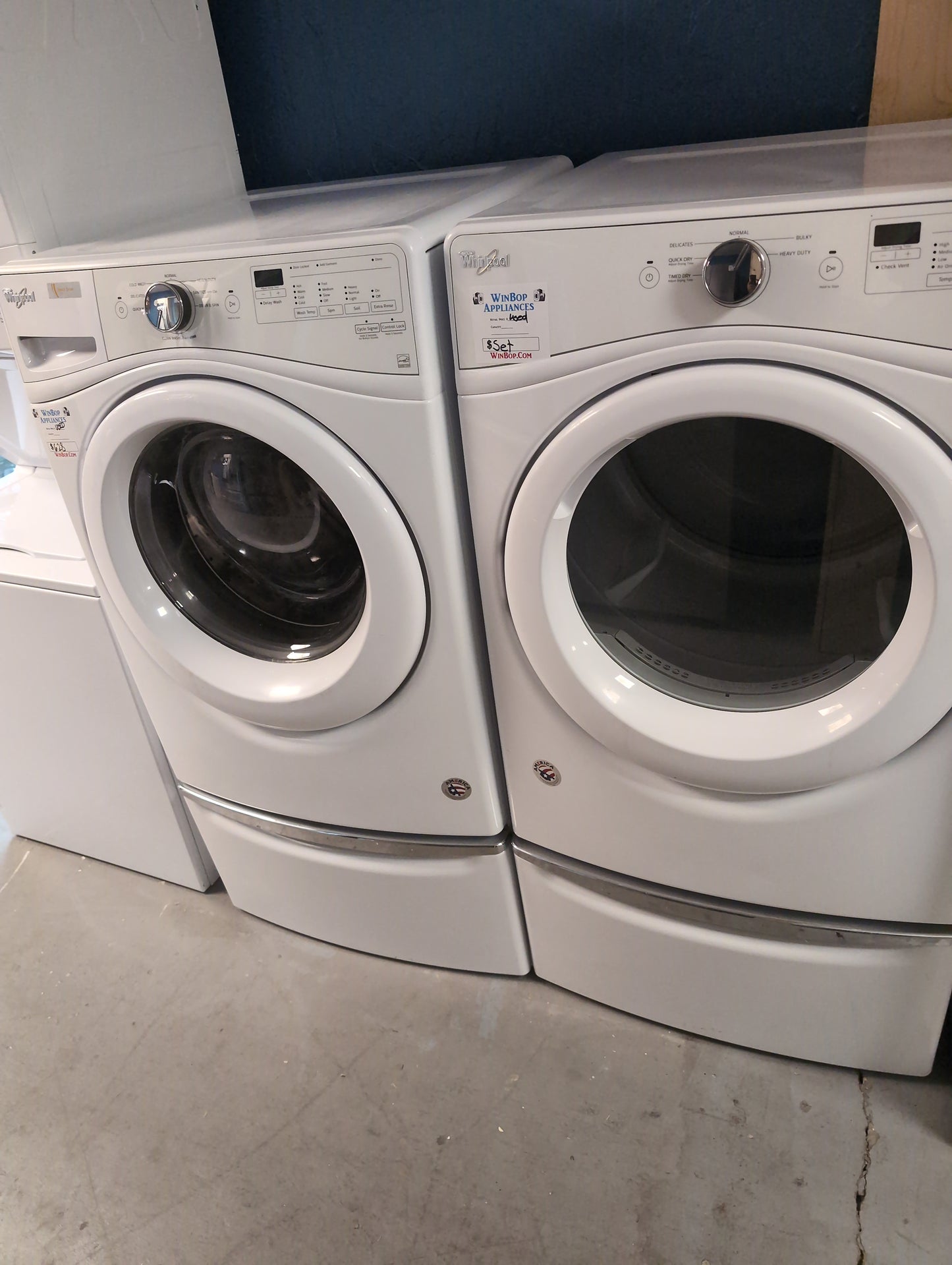 Used Whirlpool 5 Cubic ft Front Load Washer and 7.4 cubic foot electric dryer set with pedestals