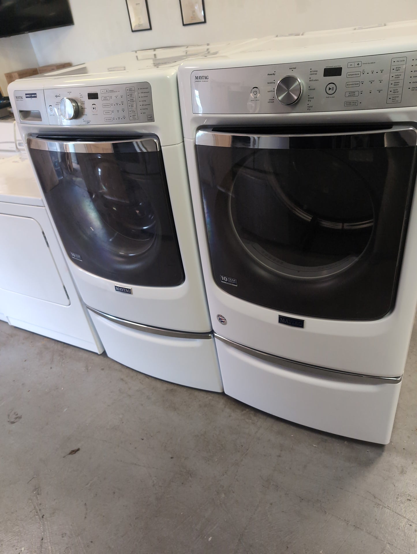 Used Maytag direct drive 4.6 cubic foot front load washer with 7.4 cubic foot electric dryer set on pedestals