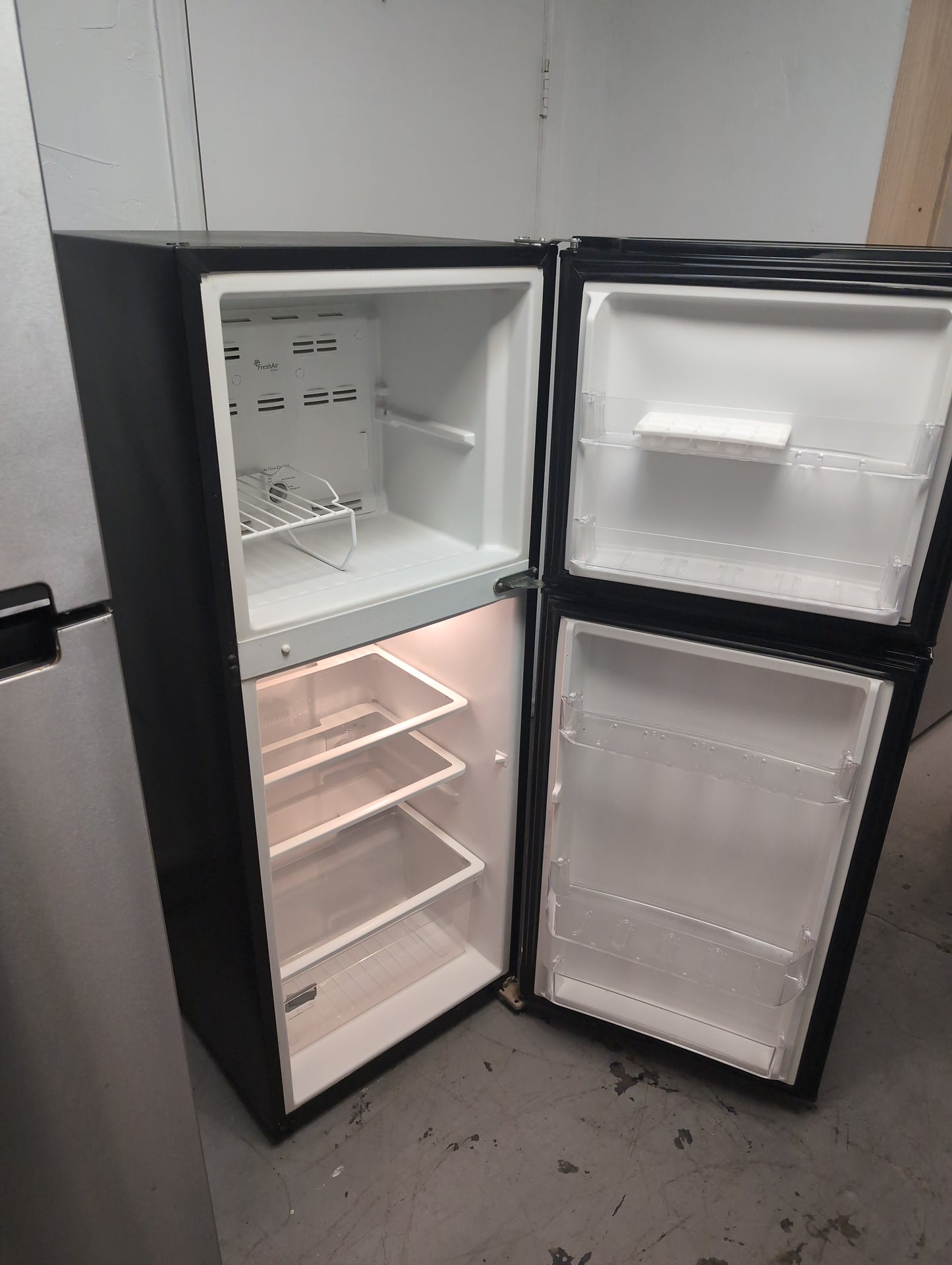 Used Whirlpool 11.6 cubic foot top freezer refrigerator. 24-in apartment size
